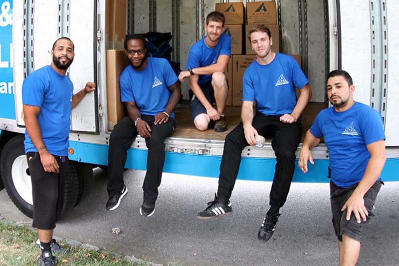 Alpha-Moving-staff Alpha Moving & Storage employees on a moving truck